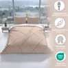 A bed with beige striped bedding is set up in a room with a large window overlooking a landscape. Produktbild-Vorschau