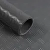 A rolled-up dark gray PVC floor covering with a diamond cut pattern. Produktbild-Vorschau