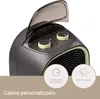 A close-up of a heater with two control knobs and a flip-up lid. Two circular icons with text are visible at the bottom. Produktbild-Vorschau