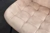 A close-up view of a tufted chair seat. Produktbild-Vorschau