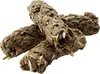 A close-up studio shot of several dried, compressed food sticks for rabbits, arranged in a pile against a white background. Podgląd zdjęcia produktu