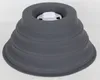 A dark gray, collapsible bowl or container with a white insert at the top sits on a white surface. Voir les images du produit