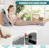 A woman is reading a book while lying on a bed with wedge pillows supporting her back and legs. Náhľad obrázku produktu