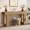 A wooden console table with decorative items on top and a basket with blankets and pillows underneath, set in a living room or entryway. Náhľad obrázku produktu