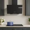 A modern kitchen scene featuring a black range hood above a black induction cooktop with a blue pot on it. Voir les images du produit