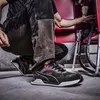 A person wearing work clothes and Puma safety shoes is working on electrical equipment. Voir les images du produit