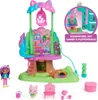 A toy playset featuring a treehouse, dolls, and accessories, presented on a white background with some marketing text. Náhled obrázku produktu