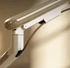 A close-up shot of a white monitor stand arm with a brown cable. Produktbild-Vorschau