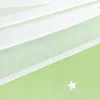 A close-up view of a green fabric with white stars and white sheer fabric draped over it. Produktbild-Vorschau