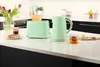A kitchen counter with a toaster, kettle, toast, jam, and drinks. Podgląd zdjęcia produktu