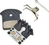 A set of bicycle brake pads and related hardware. Produktbild-Vorschau