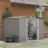 A garden shed with gardening tools and equipment inside, situated on a paved patio next to a brick building. Produktbild-Vorschau