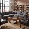 A living room setting with a sectional sofa, coffee table, and bookshelves. Voir les images du produit