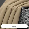 A close-up view of beige fabric with folds, next to a wicker basket.
