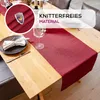 A table runner on a wooden table set for a meal. Produktbild-Vorschau