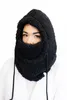 A woman wearing a black plush balaclava hood with drawstrings, against a white background. Produktbild-Vorschau