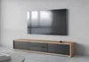 A modern TV stand with a wall-mounted television in a minimalist room. Náhled obrázku produktu