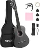A black VEVOR acoustic guitar and its accessories are displayed against a white background. The guitar is leaning against its black gig bag. Accessories include a capo, extra strings, picks, a cleaning cloth, and a strap with a tuner. Podgląd zdjęcia produktu