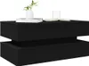 A black coffee table with two drawers, a plant, and books on top. Anteprima dell’immagine prodotto