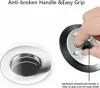A close-up of a drain stopper and a sink drain. Produktbild-Vorschau