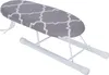 A mini ironing board with a gray and white patterned cover is shown on a white background. Produktbild-Vorschau