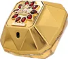 A close-up, angled view of a gold-colored perfume bottle with red jewel accents. Voir les images du produit