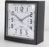 A close-up studio shot of a black analog alarm clock with a white face. Produktbild-Vorschau