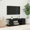 A black TV stand with a TV mounted on the wall above it, in a room with a large potted plant and a basket. Voir les images du produit