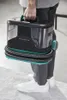 A person is holding a portable carpet cleaner. Produktbild-Vorschau