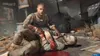 A scene from the video game Dying Light 2, showing two characters in a distressed state with blood. Produktbild-Vorschau