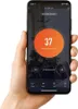 A hand holding a smartphone displaying a smart home app interface for controlling a heater. Náhľad obrázku produktu