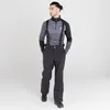 A man wearing ski pants and a long-sleeved shirt with suspenders, standing against a white background. Voir les images du produit