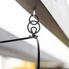 A black decorative hook is attached to a wooden beam, holding a black cable. Produktbild-Vorschau