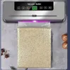 A vacuum sealer machine is shown sealing a bag of rice. Náhľad obrázku produktu