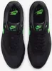 A top-down view of a pair of black Nike Air Max 1 Essential sneakers with green accents. Produktbild-Vorschau