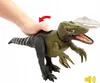 A hand is shown pressing down on the back of a toy dinosaur, with a red arrow indicating movement. Another dinosaur is blurred in the background. Náhľad obrázku produktu