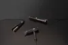 Three hair styling tools are arranged on a reflective black surface. Podgląd zdjęcia produktu