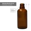 A brown glass miniature bottle with measurement indicators and text labels. Náhled obrázku produktu