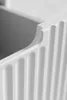 Close-up of the ribbed texture of a white cabinet. Náhled obrázku produktu
