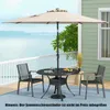 An outdoor patio set with a table, chairs, and an umbrella, overlooking a body of water. Produktbild-Vorschau