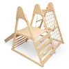A wooden indoor playground structure for children, featuring a slide, climbing wall, and rope net. Produktbild-Vorschau
