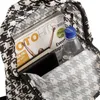 Close-up view of the inside of a backpack, showing a magazine, a wallet, and a water bottle. Produktbild-Vorschau