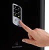 A hand is pressing a button on the control panel of a black appliance. Produktbild-Vorschau