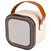 A beige and brown portable Bluetooth speaker with a leather handle, shown against a white background. Náhľad obrázku produktu