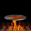 A round metal heat diffuser plate is shown heating up over a grill with flames. Produktbild-Vorschau
