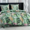 A bed with a duvet and pillows featuring a tropical leaf pattern. Náhľad obrázku produktu