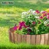 A wooden border surrounds a colorful flower bed in a grassy yard. Voir les images du produit