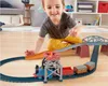 A young boy is playing with a Thomas the Tank Engine train set on the floor. Náhled obrázku produktu