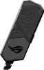 A close-up, angled shot of a black ASUS ROG Clavis AI Noise Cancelling Mic Adapter against a white background. Podgląd zdjęcia produktu
