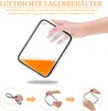 A hand holding a clear plastic food container filled with orange liquid, with instructional images below showing how to attach a seal. Náhled obrázku produktu